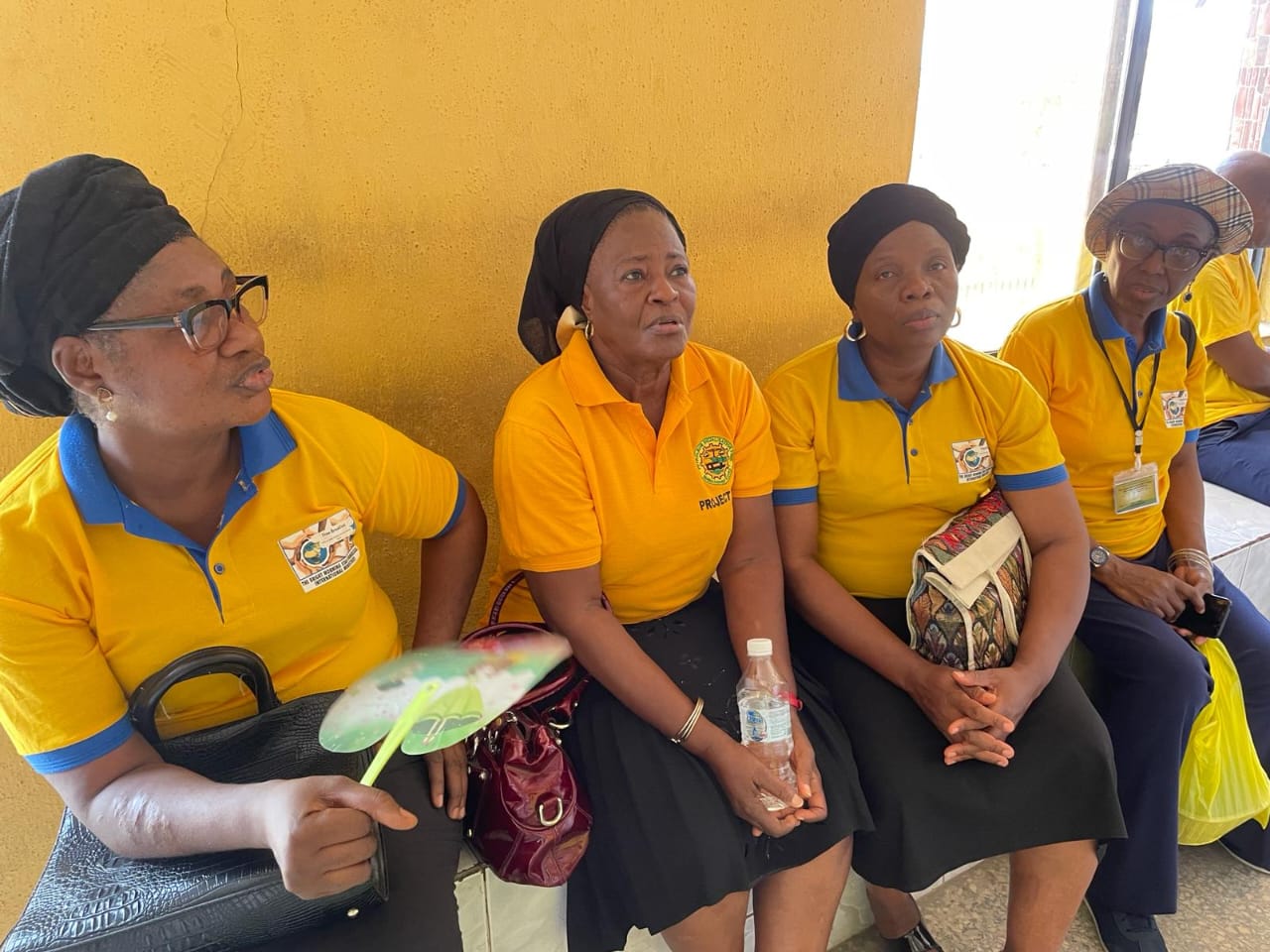 Team members seated during a police station visit
