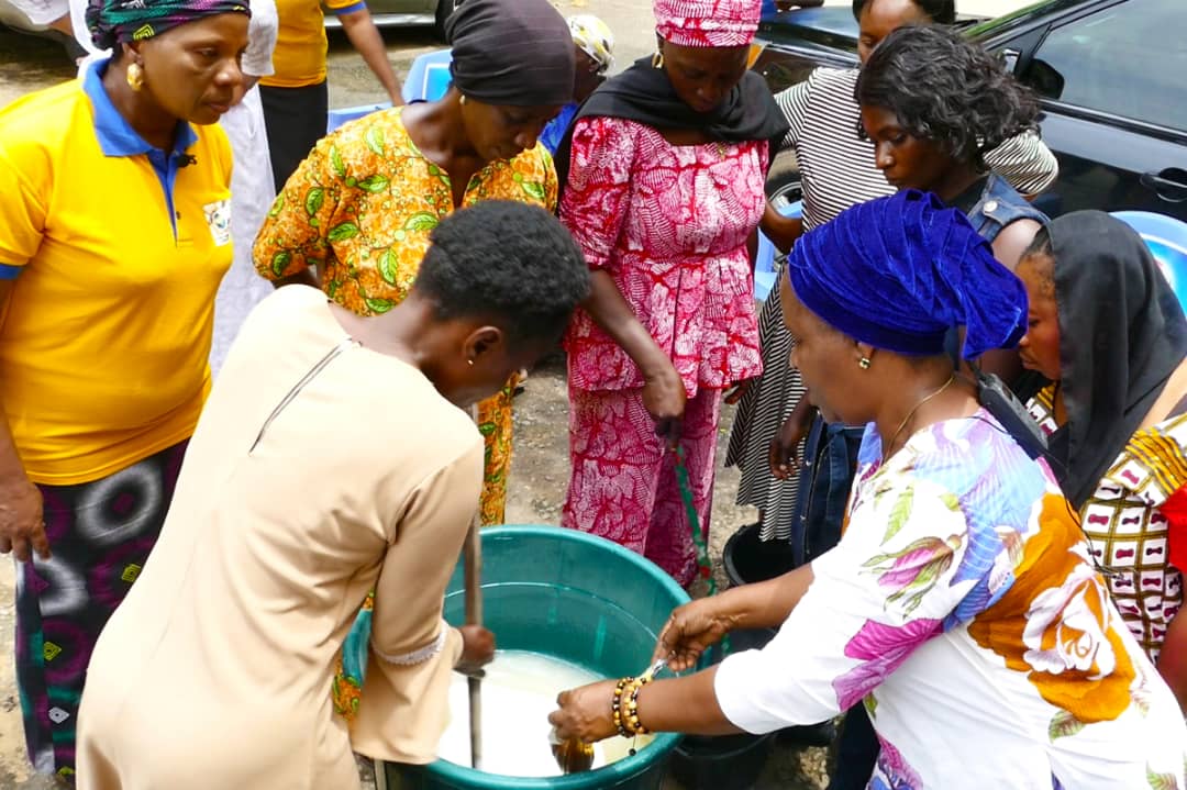 Participants learning soap making during a training session